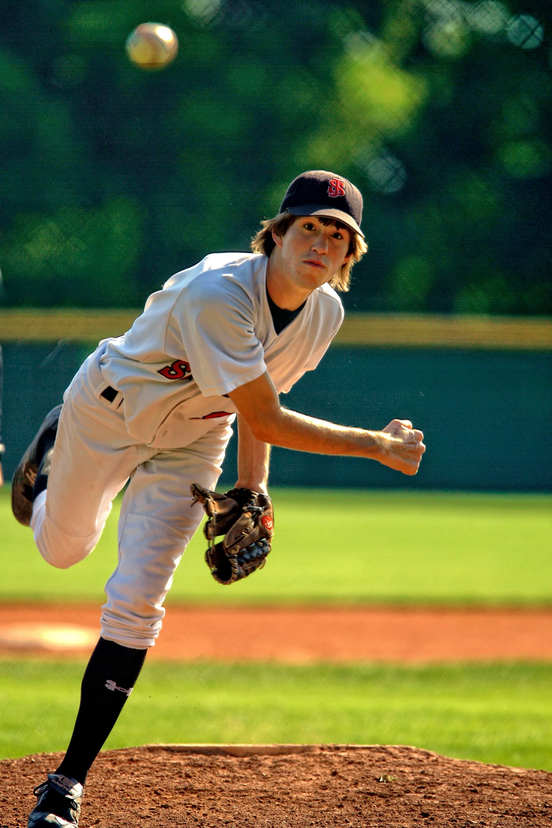 Baseball player at bat under field lights.