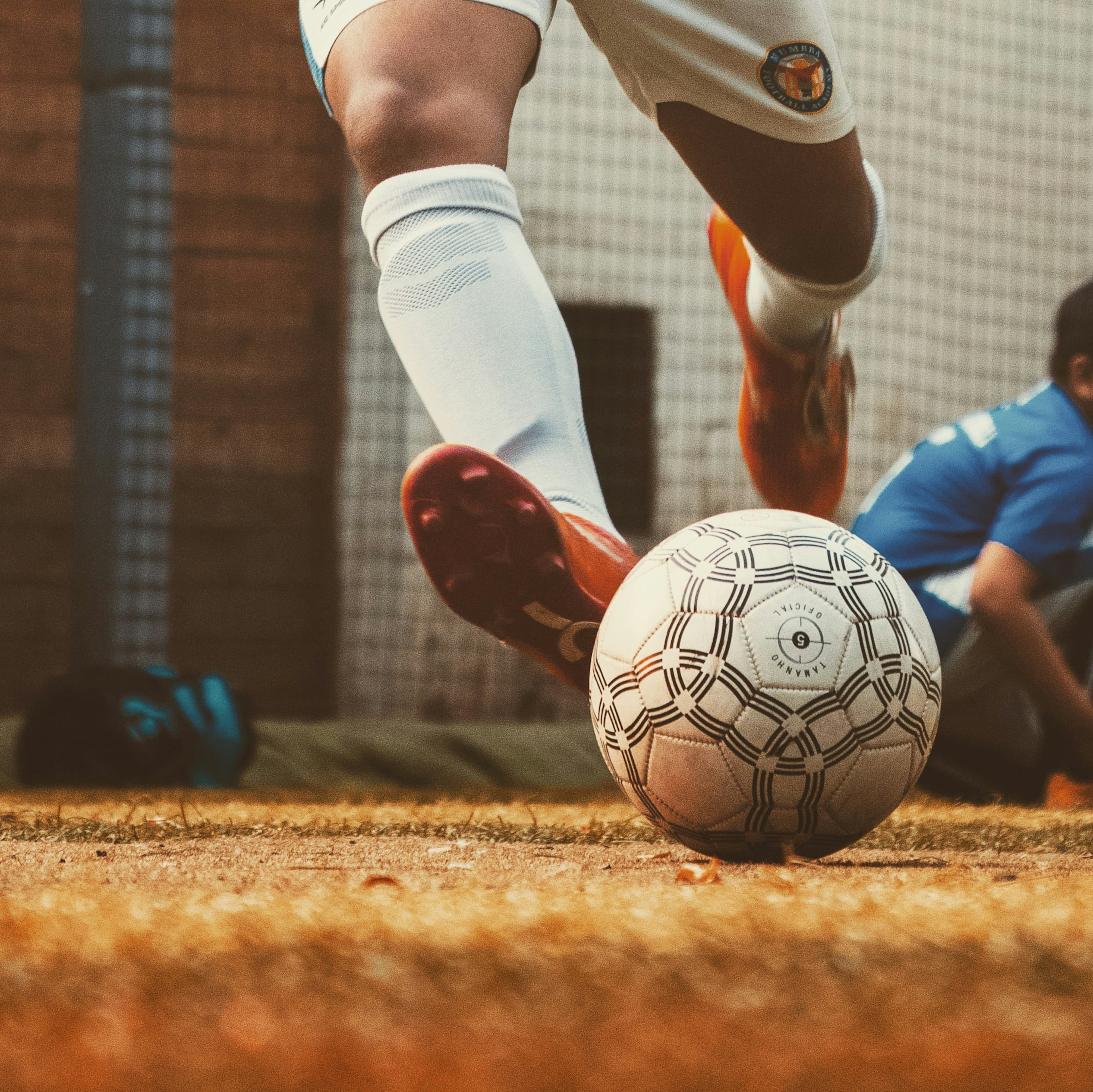 Soccer player striking a ball downfield.